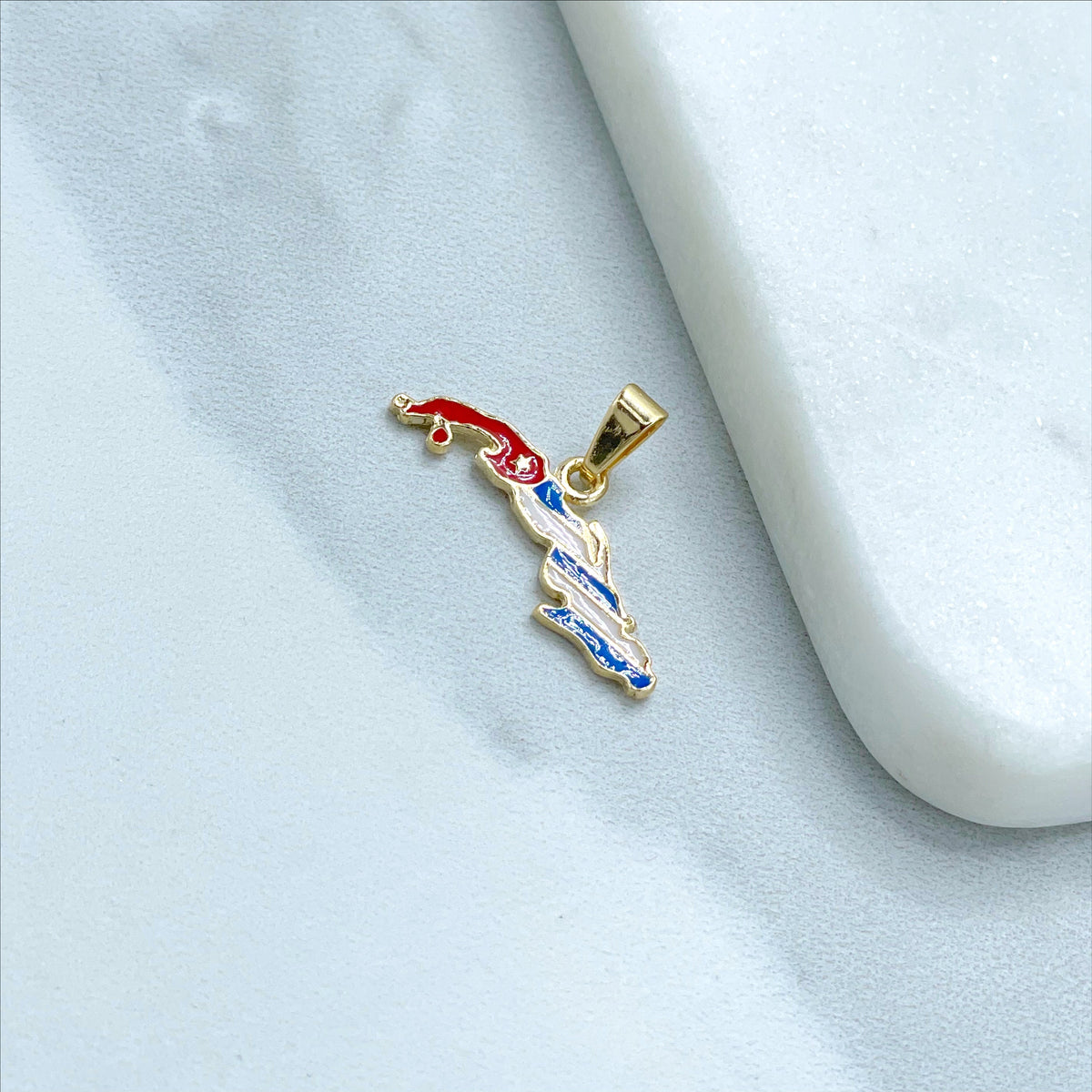 May include: Gold-colored pendant shaped like the outline of Cuba with the Cuban flag colors of red, white, and blue.